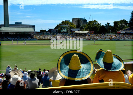 Two spectators in spectacular hats watching the cricket. WACA ground, Perth, Western Australia, Australia Stock Photo