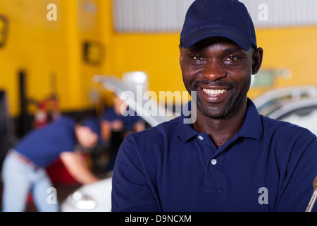 close up portrait of happy African male auto mechanic Stock Photo