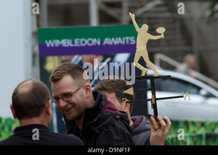 Wimbledon London. UK. 23rd June, 2013. A man holds a weather vane of a male tennis player as Wimbledon prepares to welcome visitors and fans to the 2013 tennis championships Credit:  amer ghazzal/Alamy Live News Stock Photo