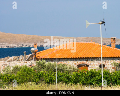 A house in Sigri on Lesvos, Greece powered by a wind turbine, sloar panels and solar thermal for heating water. Stock Photo