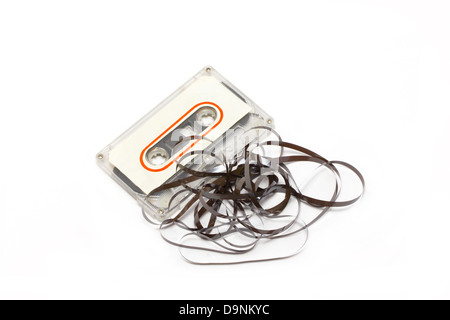 Broken audio cassette with label isolated on white background. Stock Photo