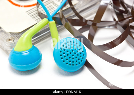 Broken audio cassette with earphones. Stock Photo