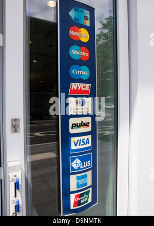 Multiple credit card brand label affixed to store entrance