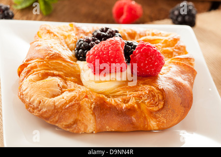 Homemade Gourmet Danish Pastry with berries and icing Stock Photo