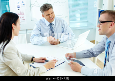 Business team discussing ideas at meeting in office Stock Photo