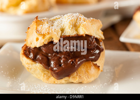 Homemade Chocolate Cream Puffs against a background Stock Photo