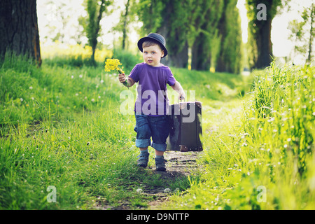 Little gentleman with big suitcase Stock Photo