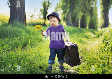 Young boy with big suitcase Stock Photo