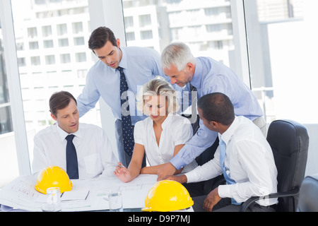 Architects working on construction plan Stock Photo