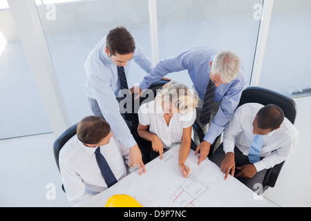Five architects working on blueprints Stock Photo