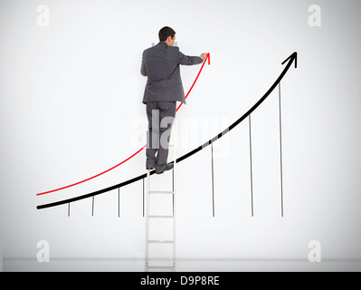 Businessman standing on ladder drawing graph Stock Photo