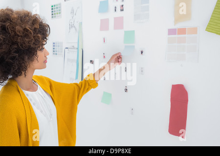 Designer standing in front of material samples Stock Photo