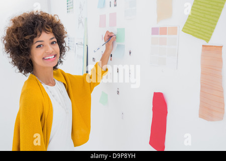 Beautiful designer standing in front of material samples Stock Photo