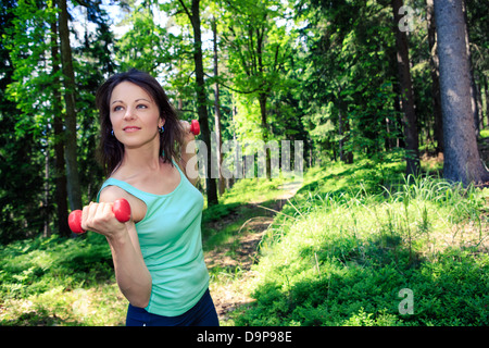 young woman jogging in a forest Stock Photo
