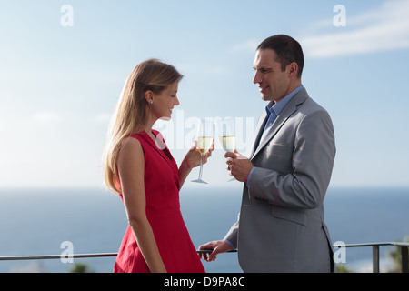 Couple clinking their flutes of champagne Stock Photo