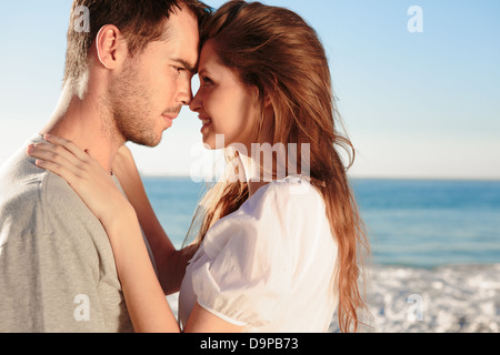 Romantic couple relaxing on the beach Stock Photo