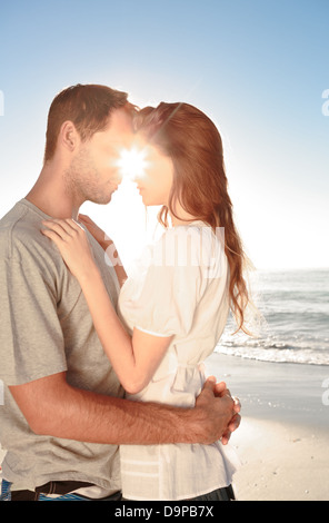 Young couple embracing on the beach Stock Photo