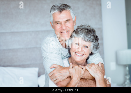 Retired couple posing together on the bed Stock Photo