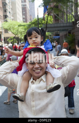 Happy young Filipino American father and daughter at the Filipino Parade on Madison Ave. in NYC. Stock Photo