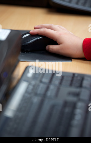 School child using a mouse in the ICT suite of a primary school in the ...