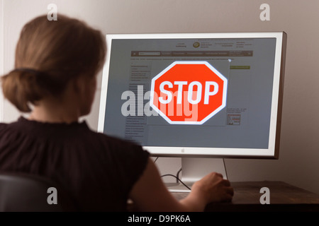 Woman looking at Internet site with blocked access Stock Photo