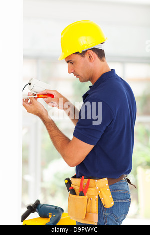 security surveillance system technician installing cctv camera Stock Photo