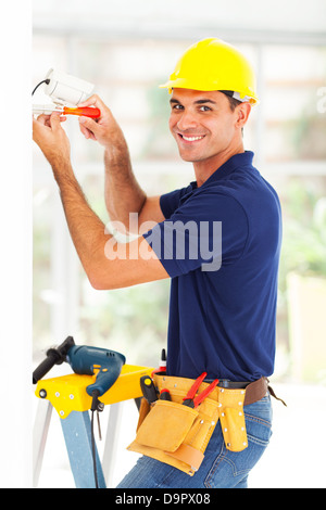 happy cctv system technician installing camera Stock Photo