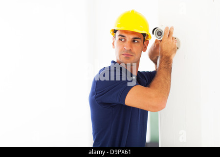 professional cctv technician adjusting security camera angle Stock Photo