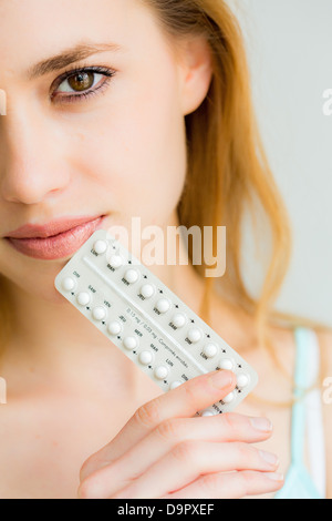 Woman holding generic contraceptive pills. Stock Photo