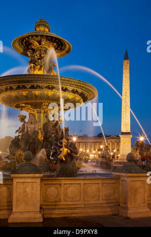 Twilight at Fontaine des Mers - Fountain of Seas in Place de la Concorde, Paris France Stock Photo