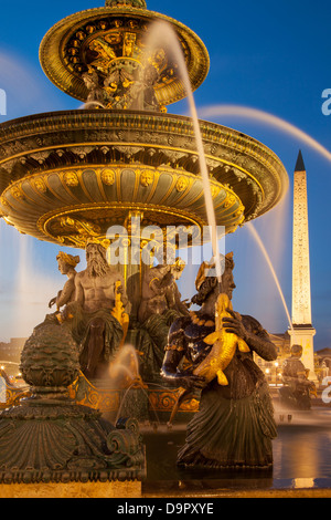 Twilight at Fontaine des Mers - Fountain of Seas in Place de la Concorde, Paris France Stock Photo