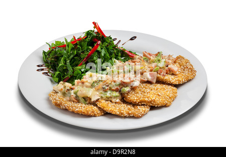 breaded bites of yogurt sauce and salad in a white bowl Stock Photo