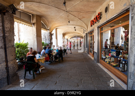 GENOA, ITALY - June 16: Tourists and locals rests in sidewalk cafes in Genoa, Italy on June 16, 2012, Genoa, Italy. Stock Photo