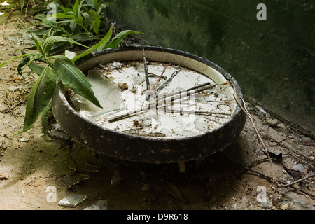 Old broken wall clock in an abandoned house Stock Photo