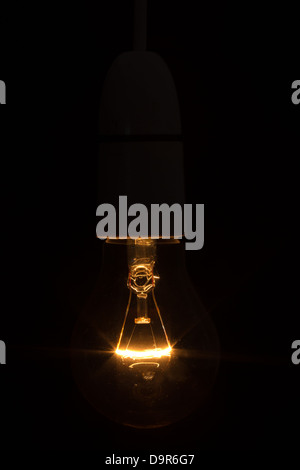 Close up of bright light bulb in the dark Stock Photo