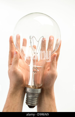 Man holding big light bulb in his hands Stock Photo