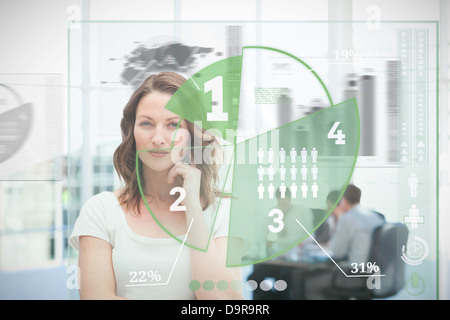Blonde businesswoman using green pie chart interface Stock Photo