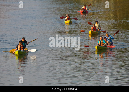 Horizontal view of people kayaking along the Nam Song river in Vang Vieng. Stock Photo