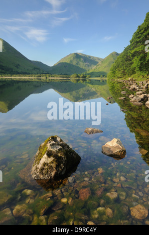 English Lake District fells reflected in Brothers Water in summer in the English Lake District Stock Photo