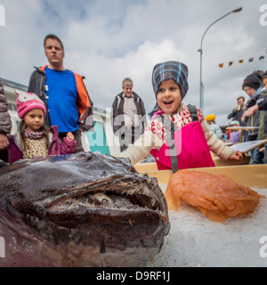 People looking at Atlantic Wolffish (Anarhichas lupus), Seaman's Day Festival, Reykjavik, Iceland. Stock Photo