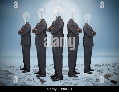 Businessman with bulb head multiplied standing on floor of graphs Stock Photo