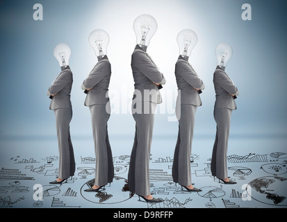Businesswoman with bulb head multiplied standing on floor of graphs Stock Photo