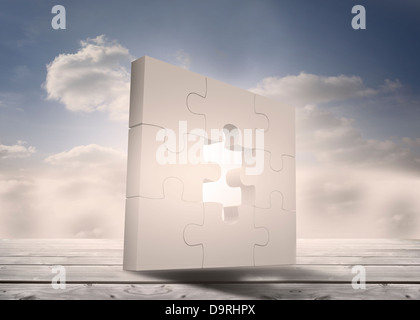 Jigsaw puzzle unfinished standing on floorboards in the sky Stock Photo