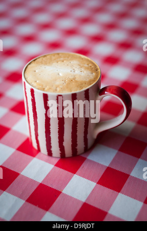 Cappuccino on a red checkered tablecloth Stock Photo