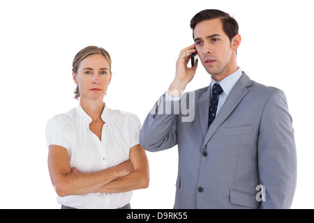 Businessman on the phone next to his colleague Stock Photo