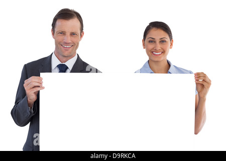 Smiling co workers holding a blank copy space Stock Photo