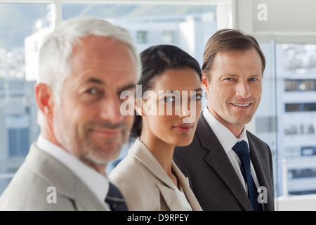 Serious business people looking in the same way Stock Photo