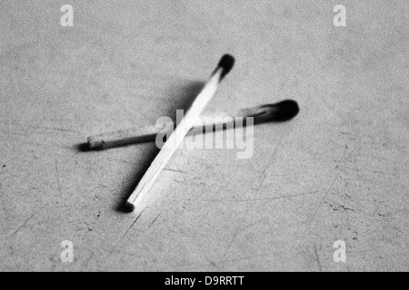 the black and white image of two burnt matches Stock Photo