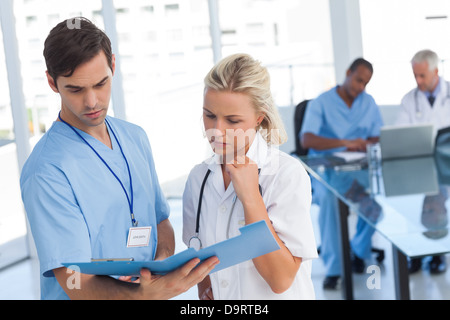 Two doctors examining a file Stock Photo