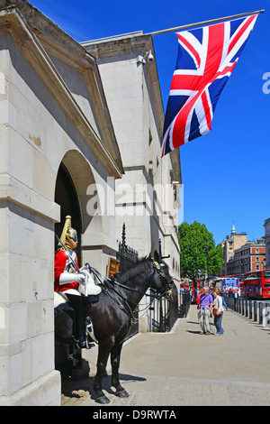 Whitehall pavement with Household Cavalry mounted trooper and Union Jack flag Whitehall London England UK Stock Photo